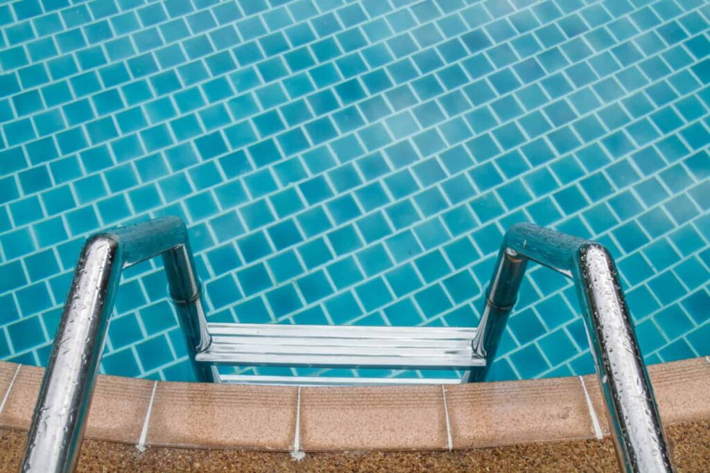 Piscina con suelo de azulejos limpia con vista desde las escaleras